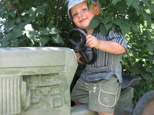 Jaengus just had to sit on every idle tractor in Vermont, he even founfdthis one just his size at the Von Trapp Dairy Farm